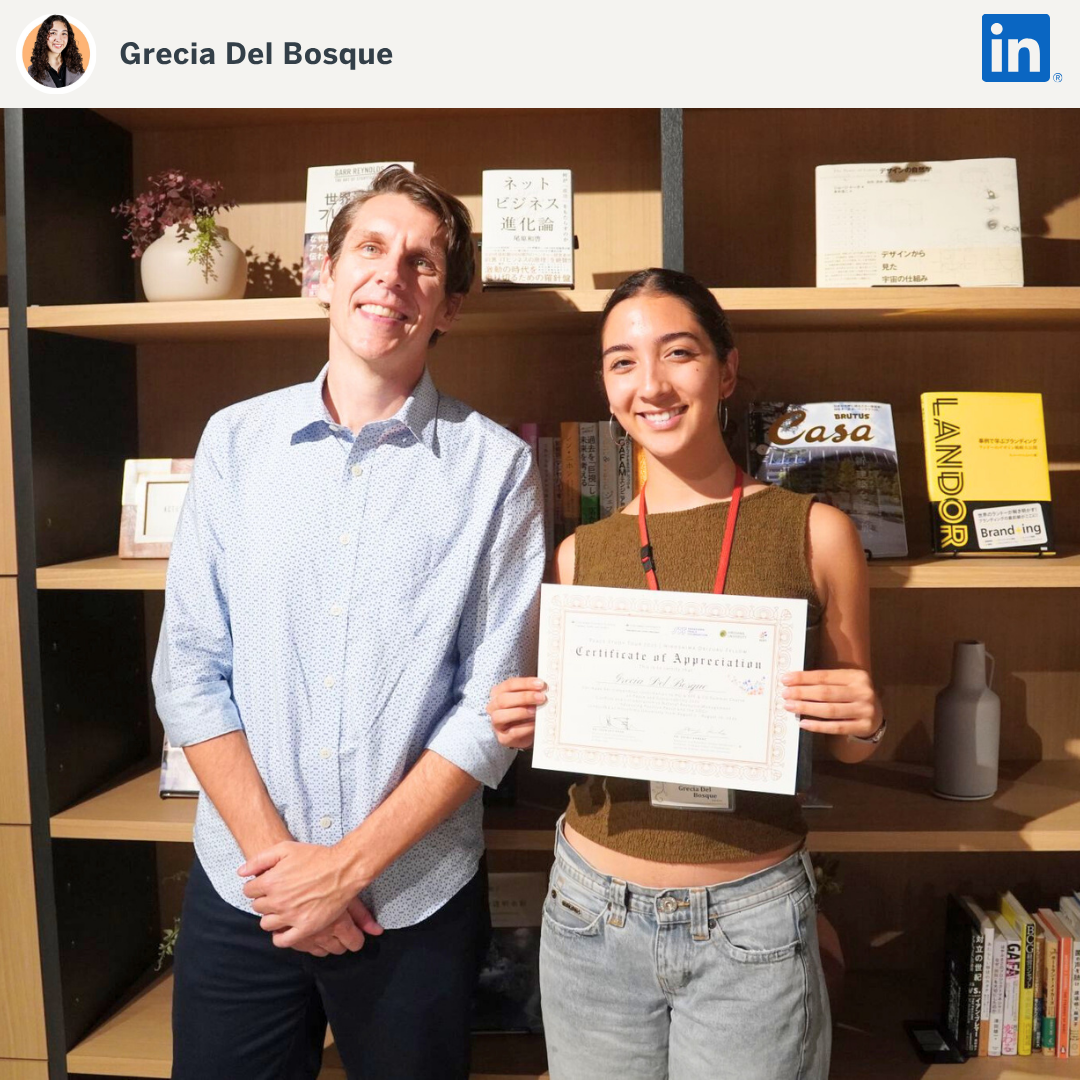 Student posing with award